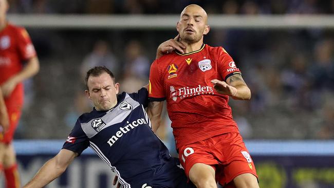 MELBOURNE, AUSTRALIA - FEBRUARY 29: Leigh Broxham of the Victory  (L) challenges James Troisi of Adelaide United  during the round 21 A-League match between the Melbourne Victory and Adelaide United at Marvel Stadium on February 29, 2020 in Melbourne, Australia. (Photo by Graham Denholm/Getty Images)