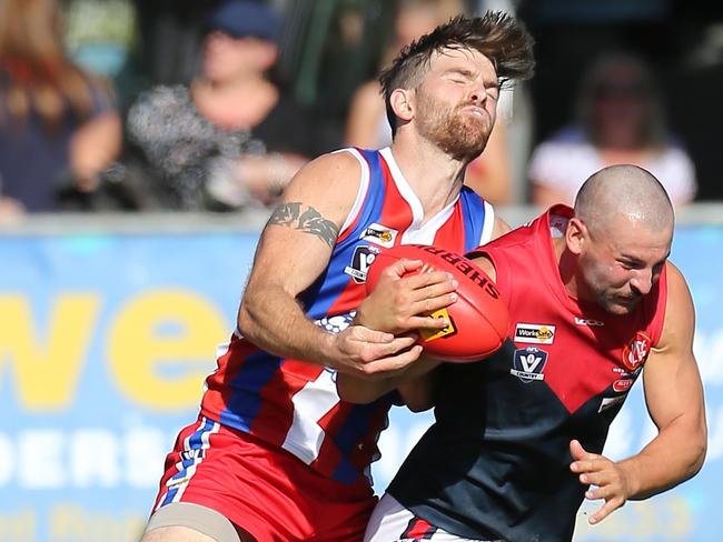 Leigh Warne lays a tackle on a Koo Wee Rup opponent. Picture: Yuri Kouzmin