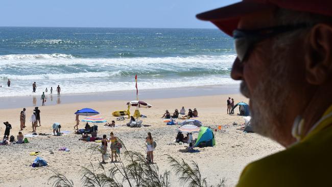 ON DUTY: Veteran Rainbow Beach lifeguard Ron Organ was keeping watch over a big crowd of bathers on Sunday.