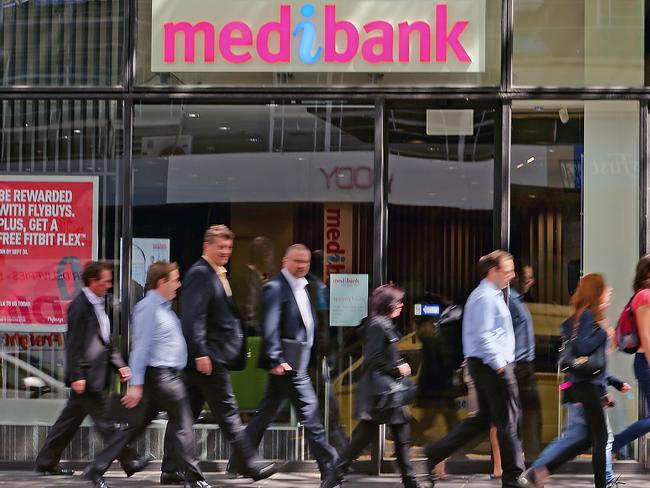 MELBOURNE, AUSTRALIA - OCTOBER 01:  People walk past a Medibank branch on October 1, 2014 in Melbourne, Australia.  The Abbott government is privatising Australia's largest health insurer, Medibank Private in what will be the biggest Australian initial public offering since 2010. Medibank Private will list on the Australian Stock Exchange in December of this year.  (Photo by Scott Barbour/Getty Images)