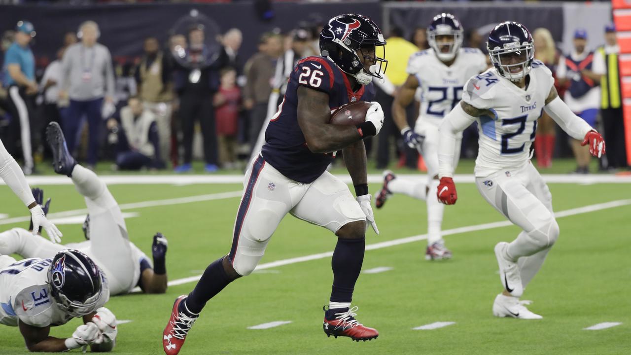 Houston Texans running back Lamar Miller breaks away from Tennessee Titans defenders for a 97-yard touchdown run.