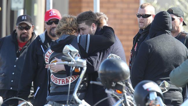 Machhour Chaouk's son Omar is embraced by a Hells Angel member at his father's funeral at Preston Mosque.