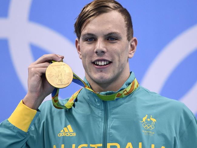 Australia's Kyle Chalmers poses with his gold medal on the podium of the Men's 100m Freestyle Final during the swimming event at the Rio 2016 Olympic Games at the Olympic Aquatics Stadium in Rio de Janeiro on August 10, 2016. / AFP PHOTO / Martin BUREAU