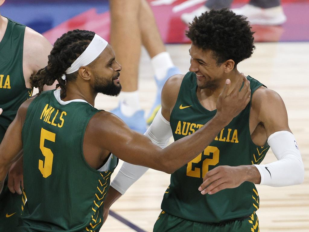 Patty Mills with teammate Boomers Matisse Thybulle. Picture: AFP