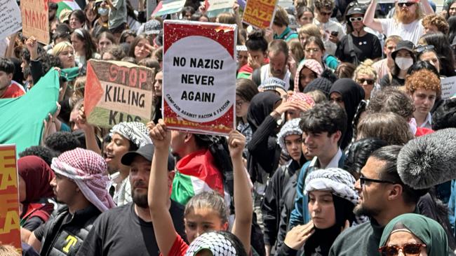 A girl holds aloft a sign saying ‘No Nazis every again’. Picture: Suzan Delibasic