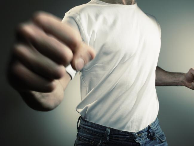 man in white t shirt and jeans throwing punch with motion blur -add text/graphics