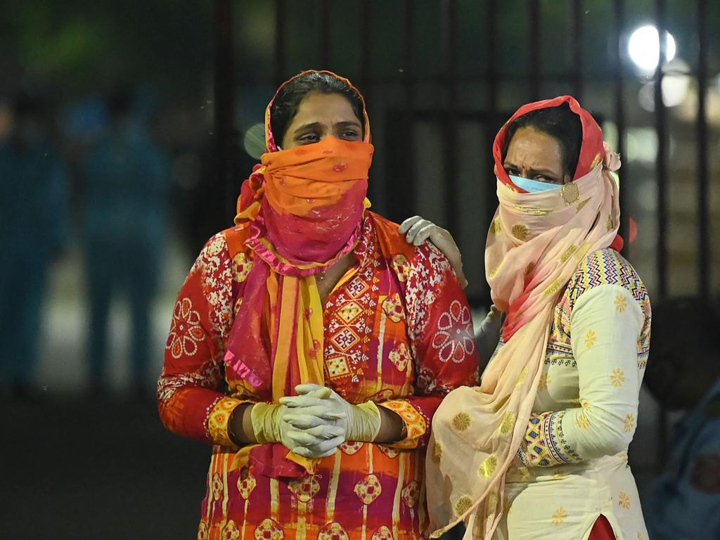 Relatives of a COVID-19 victim mourn during a cremation at Nigambodh Ghat Crematorium, on the banks of the Yamuna river in New Delhi. Picture: AFP