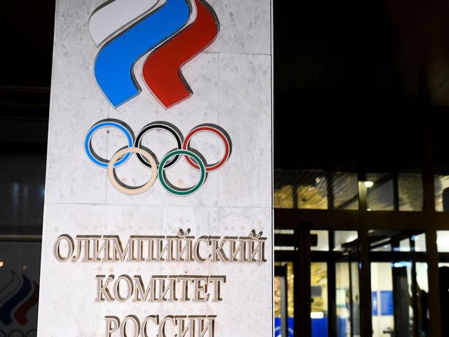 TOPSHOT - A person walks out of the Russian Olympic Committee (ROC) headquarters in Moscow on December 9, 2019. - Russia will miss next year's Tokyo Olympics and the 2022 Beijing Winter Games after the World Anti-Doping Agency on Monday banned the powerhouse from global sporting events for four years over manipulated doping data. (Photo by Alexander NEMENOV / AFP)