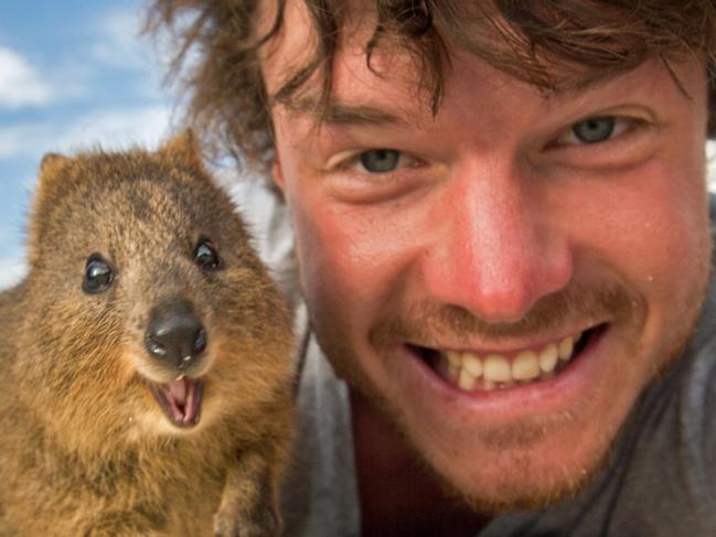 ***HOLD CONTACT BRISBANE*** MUST CREDIT DAXON / CATERS NEWS / PICTURE MEDIA FOR BRISBANE COURIER MAIL UP TO 6 IMAGES IN PRINT AND WHOLE SET ONLINE PIC BY @DAXON / CATERS NEWS - (PICTURED: Allan Dixon takes selfie with quokka) This real-life Dr. Dolittle walks with the animals, talks with the animals, and... TAKES SELFIES with them. Traveller Allan Dixon has amassed a hilarious collection of shots with a variety of exotic creatures. Included in the 29-year-olds collection are smiling snaps with the likes of kangaroos, quokkas, camels and sea lions. In some of the shots, Allan, who is originally from Wicklow, Ireland, can even be seen in festive poses, placing a Santa hat on himself or his furry friends. - SEE CATERS COPY