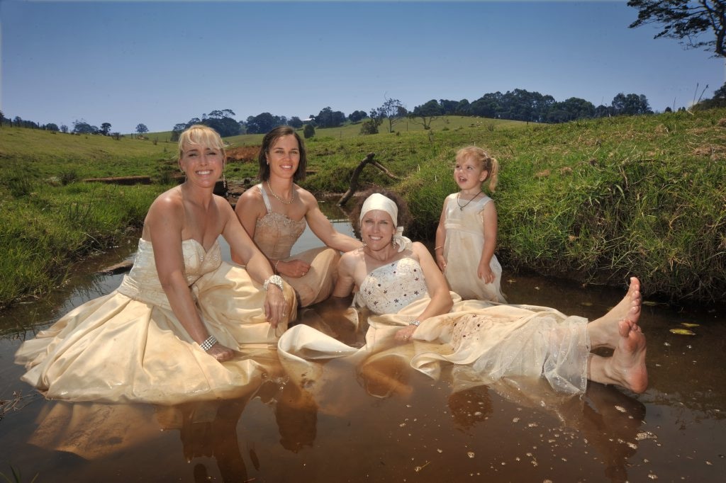 Trash Your Wedding Dress fundraiser at Maleny Dairy: Getting down and dirty in the creek are Kay Hollyoak, left, Sally Hopper, Beth Newton and Cheeky Hopper. Photo: Brett Wortman / Sunshine Coast Daily. Picture: Brett Wortman