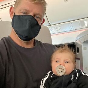 Mick Fanning and baby Xander on the way to America. Photo: Instagram @mfanno