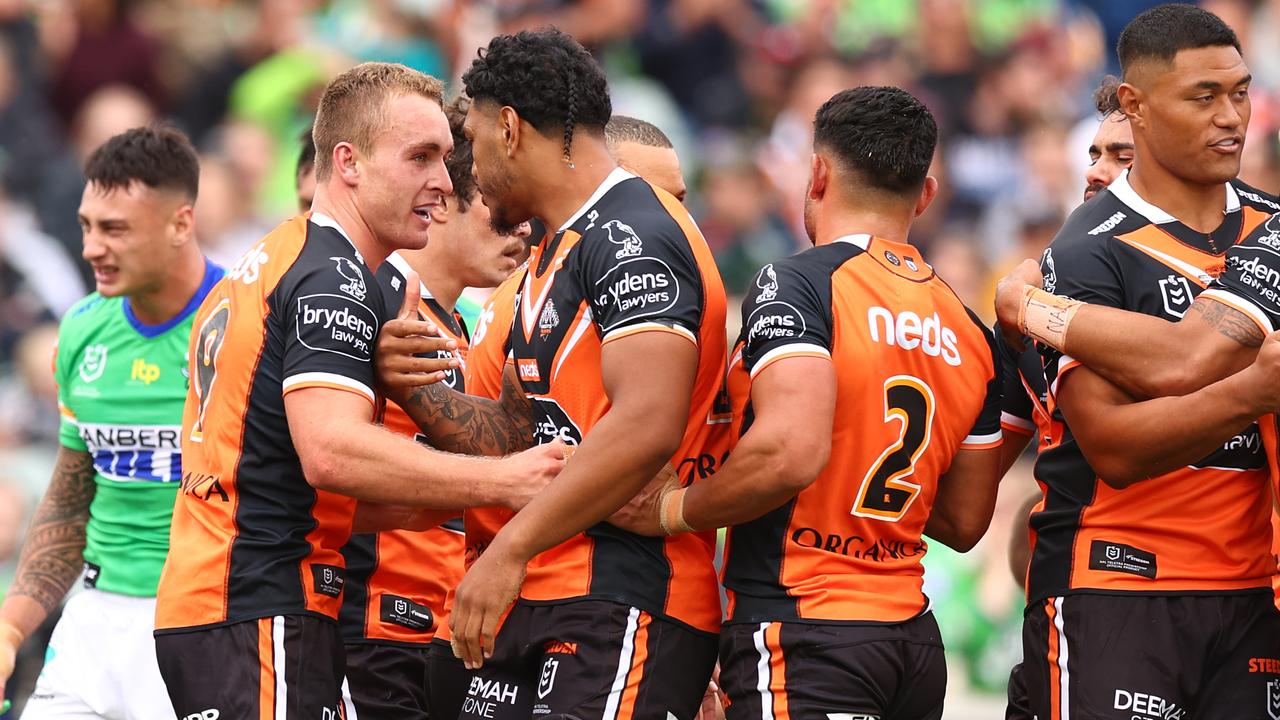 Jacob Liddle of the Tigers celebrates scoring a try with teammates (Photo by Mark Nolan/Getty Images)