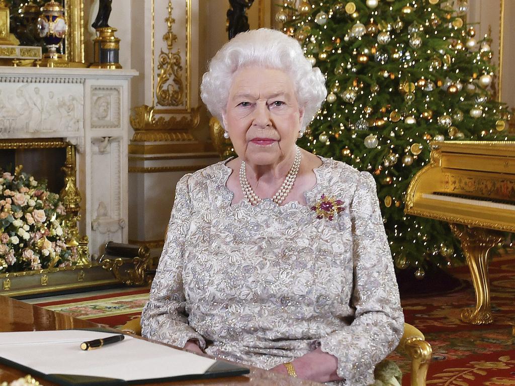 Queen Elizabeth II will wear a cocktail dress in ivory silk designed by Angela Kelly, along with a gold Scarab brooch. Picture: John Stillwell/AP