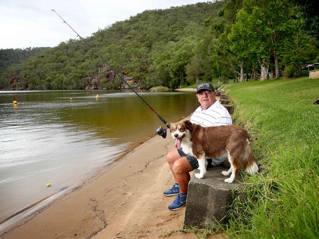 Greg Hartley with his dog Elly enjoying the quiet life on the Hawkesbury River. Picture: Toby Zerna