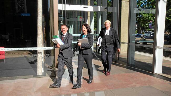 Esther Rockett (centre) leaves Sydney Supreme Court with solicitor Stewart O&#39;Connell and barrister Tom Molomby after a hearing on costs after Serge Benhayon&#39;s defamation case against her failed last year. Picture: Liana Turner