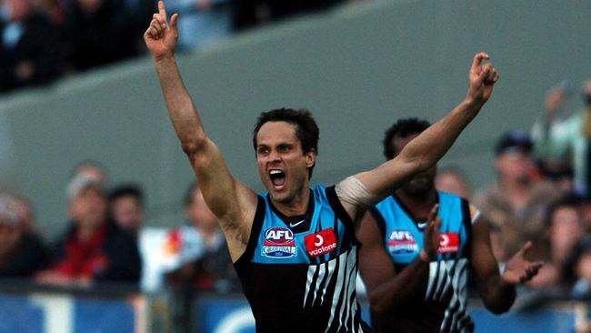 Gavin Wanganeen celebrates one of his four goals late in the 2004 grand final.