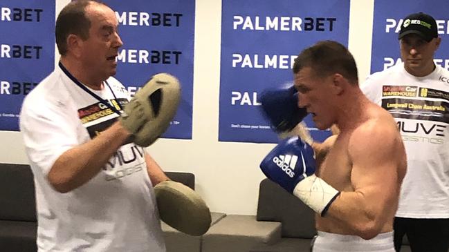 Paul Gallen warms-up with trainer Graeme Shaw.