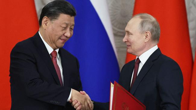 Russian President Vladimir Putin and China's President Xi Jinping shake hands during a signing ceremony following their talks at the Kremlin in Moscow on March 21, 2023. (Photo by Mikhail TERESHCHENKO / SPUTNIK / AFP)