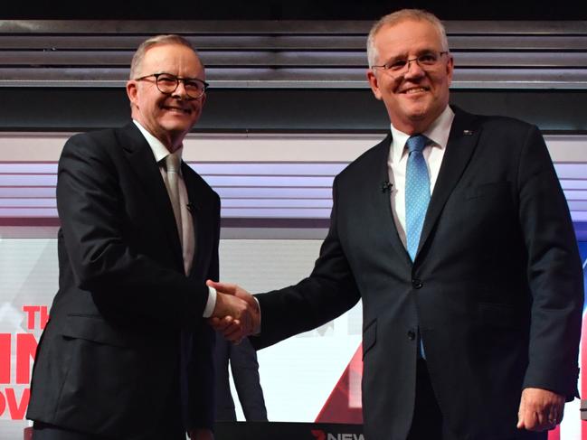 Prime Minister Scott Morrison (R) and Opposition Leader Anthony Albanese shake hands during a leaders debate.