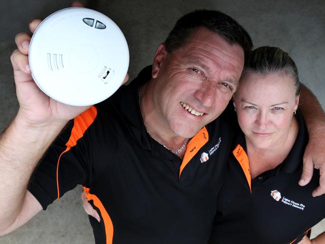 Logan House Fire Support Network fire safety campaign founders Louie and Christine Naumovski with a new photoelectric smoke detector. Picture: Renae Droop