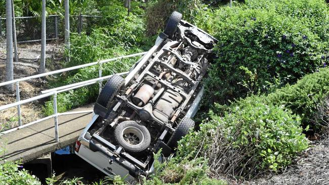 A car is perched down an embankment following a single car rollover on Shute Harbour Rd at Cannonvale this morning. Picture: Claudia Alp