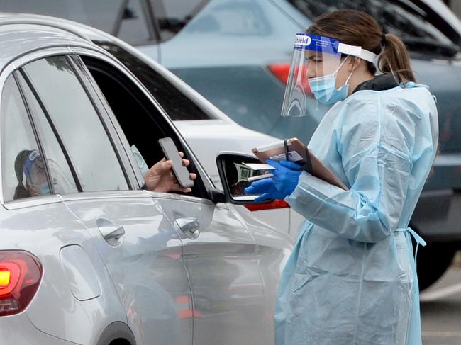 MELBOURNE, AUSTRALIA - NewsWire Photos MAY 28, 2021: A medical worker speaks to people as they queue at a COVID testing station at Deer Park on the first day of lockdown. Picture: NCA NewsWire / Andrew Henshaw