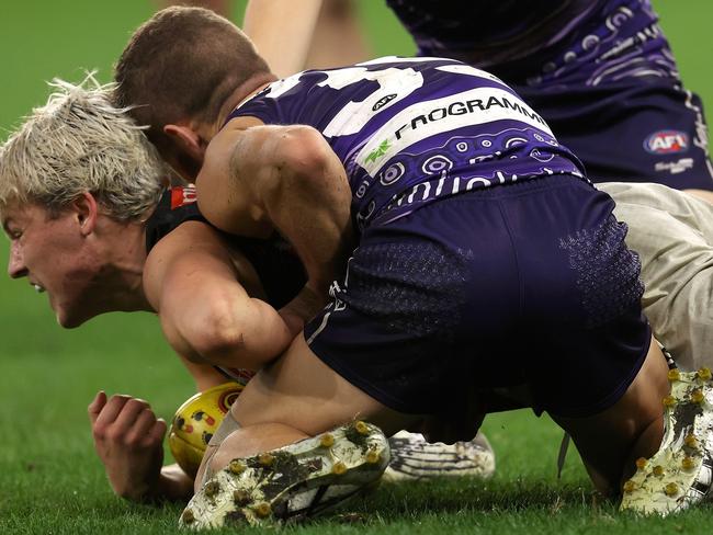 PERTH, AUSTRALIA - MAY 22: Sam Switkowski of the Dockers tackles Jack Ginnivan of the Magpies during the round 10 AFL match between the Fremantle Dockers and the Collingwood Magpies at Optus Stadium on May 22, 2022 in Perth, Australia. (Photo by Paul Kane/Getty Images)