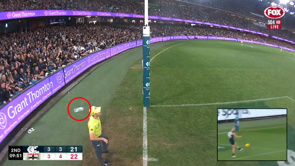 The moment a bottle of water collided with an AFL umpire.