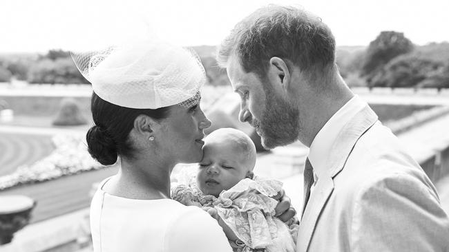 A source close to Harry says the memoir will feature a lot about Meghan as the woman who liberated him to deal with all the pain. Pictured are Prince Harry with his wife, Meghan, and their son, Archie, following his christening. Picture: AFP