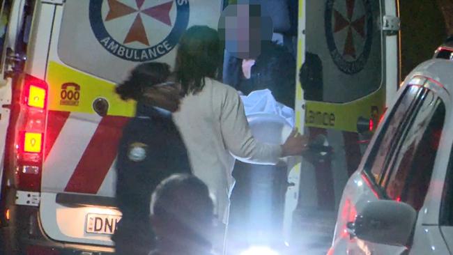 The mother of the dead three-year-old sits, distraught, in the back of an ambulance at the scene of the tragedy. Picture: Top Notch Video