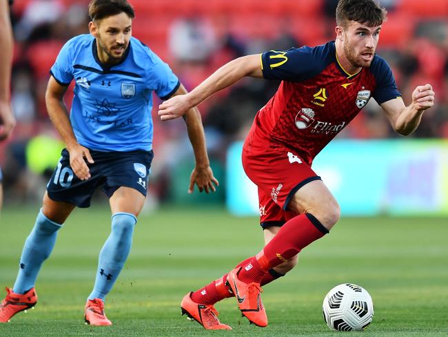 ADELAIDE, AUSTRALIA - MARCH 28:  Ryan Strain of Adelaide United gets a way from Milos Ninkovic of Sydney FC during the A-League match between Adelaide United and Sydney FC at Coopers Stadium, on March 28, 2021, in Adelaide, Australia. (Photo by Mark Brake/Getty Images)