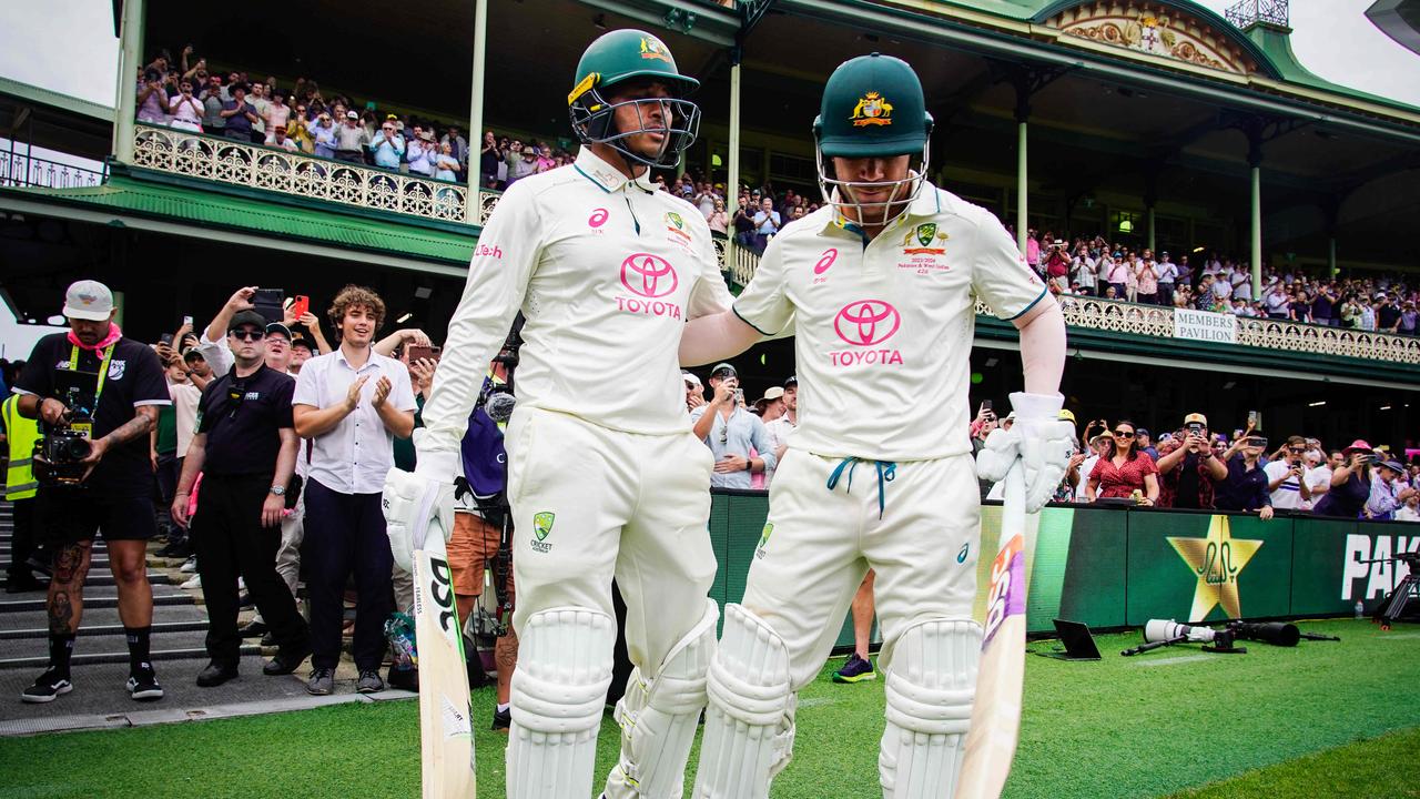 Warner and Usman Khawaja walk out onto the SCG together. Photo: Tom Parrish