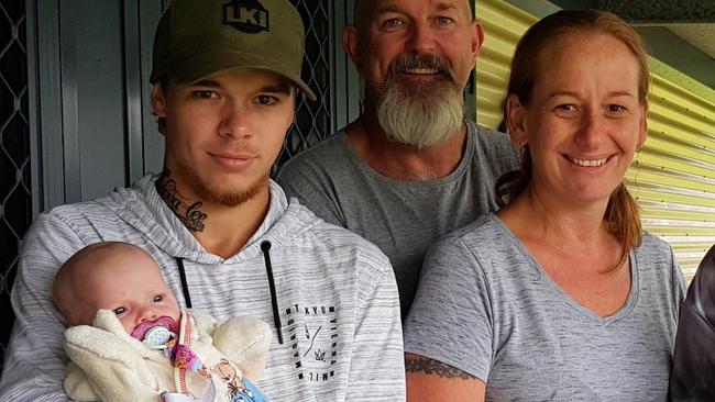 Caleb Arthur with mum Kerri and her partner Mark and extended family. Caleb is holding his baby daughter Nova