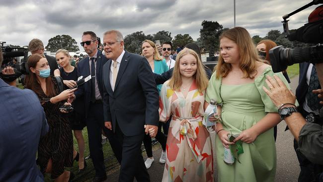 Scott Morrison’s daughters share a moment as the media attempts to ask questions of the Prime Minister in Canberra. Picture: NCA NewsWire / Gary Ramage