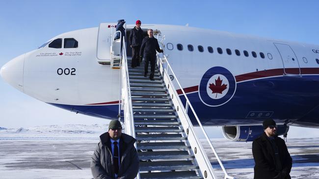 Canada Prime Minister Mark Carney and wife Diana Fox Carney arrive in Iqaluit, Nunavut, on Tuesday for the over-the-horizon radar announcement. (Sean Kilpatrick/The Canadian Press via AP)