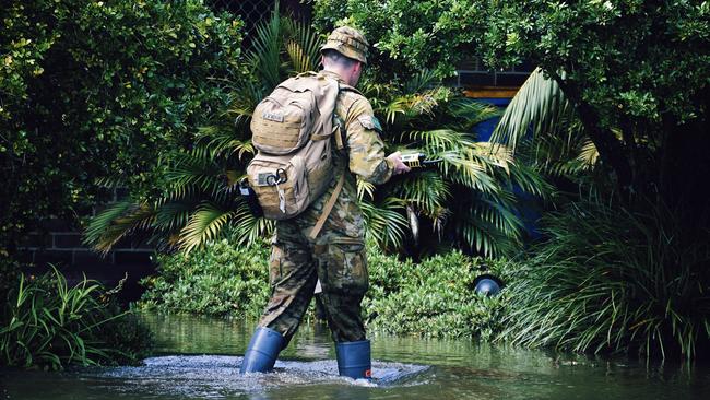 An Army Defence Force personnel doorknocks West Ballina residents as floodwaters rise on Monday March 30, 2022.. Picture: Tessa Flemming.