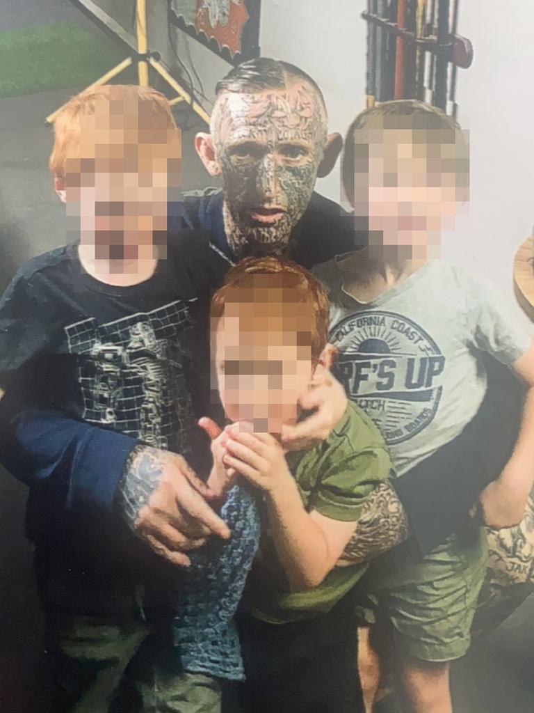 Michael Hartley pictured with his nephews the week before he died. His body was found on a Gympie property and police are looking for a man in relation to the death.