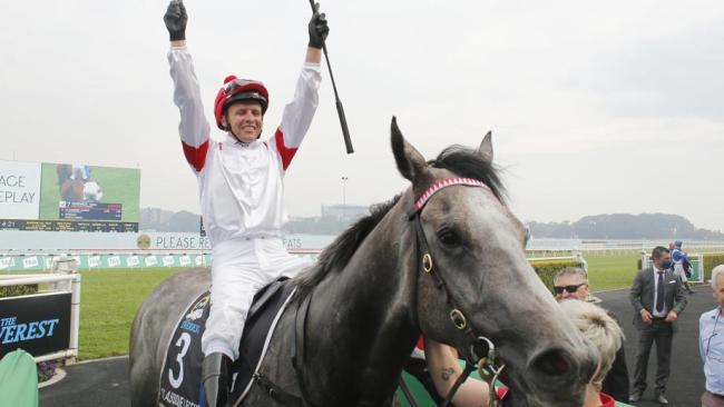 Kerrin McEvoy salutes after returning to winners' stall on Classique Legend.