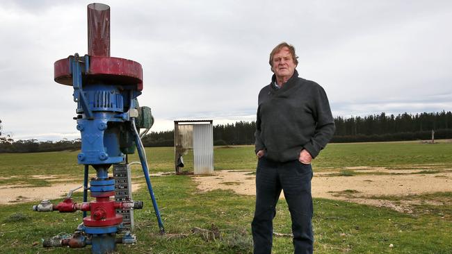 Gregor McNaughton with one of the gas wells on his property near Seaspray, in Gippsland. Pic: Aaron Francis