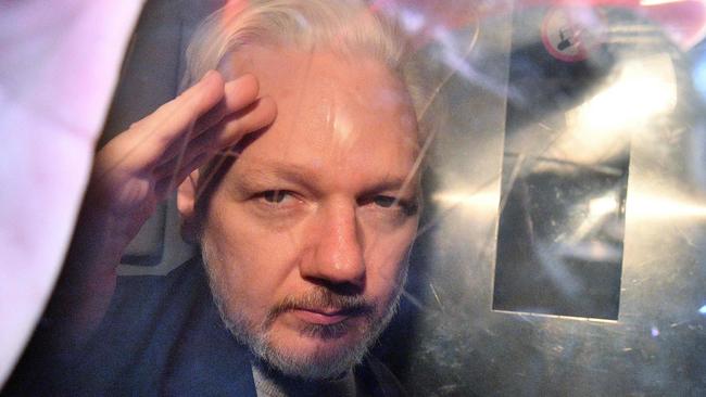 WikiLeaks founder Julian Assange gestures from the window of a prison van in 2017 as he is driven out of Southwark Crown Court in London, after having been sentenced to 50 weeks in prison for breaching his bail conditions in 2012. Picture: Daniel Leal-Olivas/AFP