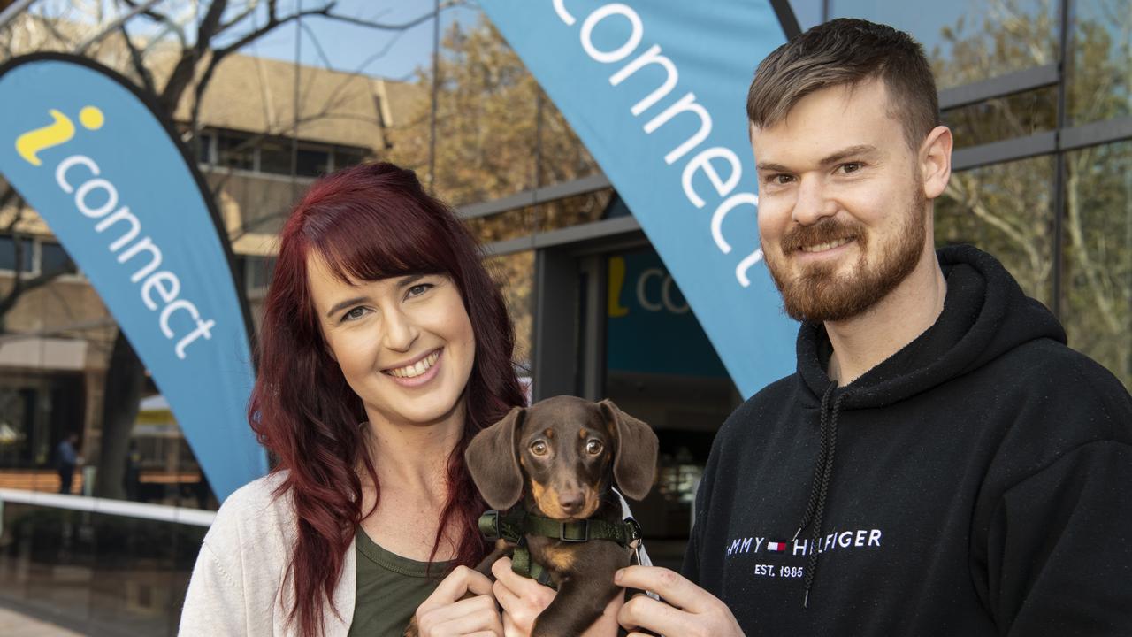 Crystal Mackean with Pepper the miniature dachshund and Andrew Murray at USQ open day. Sunday, August 15, 2021. Picture: Nev Madsen.