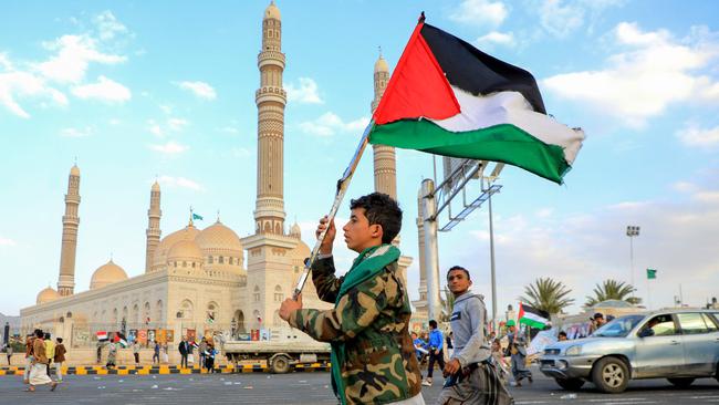 A Yemeni youth waves a Palestinian flag during a march in solidarity with the people of Gaza, in the Houthi-controlled capital Sanaa. Picture: AFP