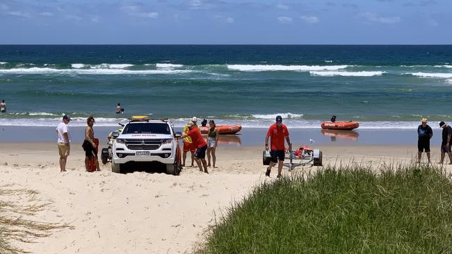 Lifesavers and other people search for Alane Etoundi at Lennox Head on Saturday. Picture: Liana Walker