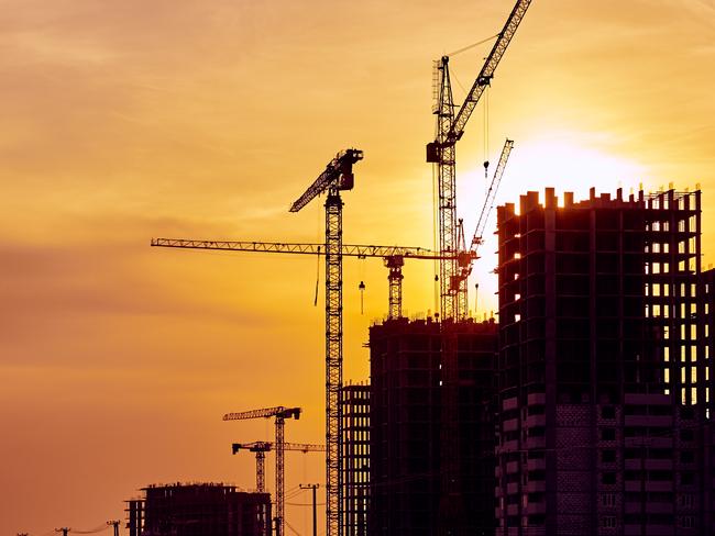 Construction site at dusk evening yellow back light, crane