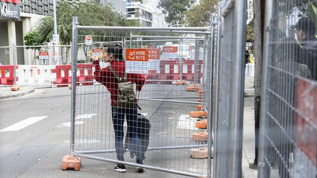 Residents attempt to access the building to collect belongings. Picture: Darren Leigh Roberts