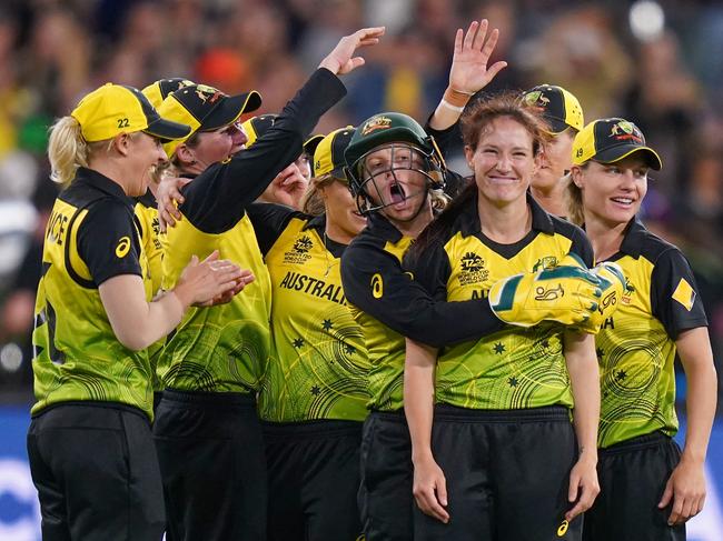 Megan Schutt of Australia celebrates with  Alyssa Healy after dismissing Shikha Pandey of India during the Women's T20 World Cup final match between Australia and India at the MCG in Melbourne, Sunday, March 8, 2020. (AAP Image/Scott Barbour) NO ARCHIVING, EDITORIAL USE ONLY, IMAGES TO BE USED FOR NEWS REPORTING PURPOSES ONLY, NO COMMERCIAL USE WHATSOEVER, NO USE IN BOOKS WITHOUT PRIOR WRITTEN CONSENT FROM AAP