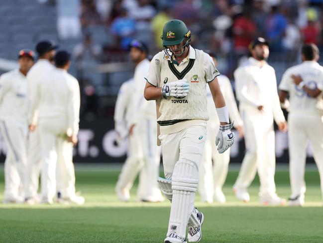 PERTH, AUSTRALIA - NOVEMBER 22: Pat Cummins of Australia walks off the field after being dismissed by Jasprit Bumrah of India for 3 runsduring day one of the First Test match in the series between Australia and India at Perth Stadium on November 22, 2024 in Perth, Australia. (Photo by Cameron Spencer/Getty Images)