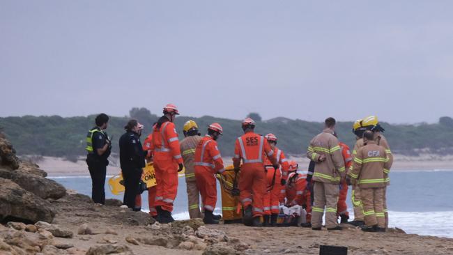 Emergency crews worked to free the woman, who become stuck in rocks at Torquay between Cosy Corner and Fishermans Beach. Picture: Shaun Viljoen