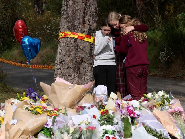 Students from a local school pictured at the scene amongst th shrine of flowers. Picture: Damian Shaw