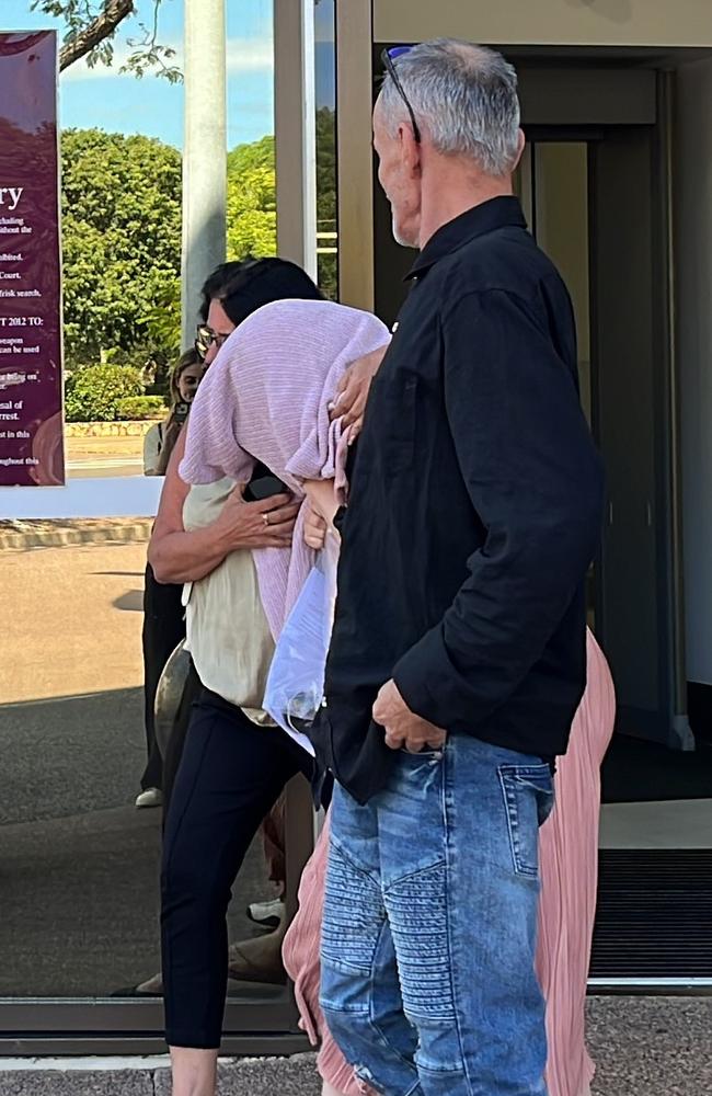 A Top End childcare centre manager Tara Eva Harding is escorted from Darwin Local Court bundled in a pink sweater by her family after facing commercial quantity drug charges.